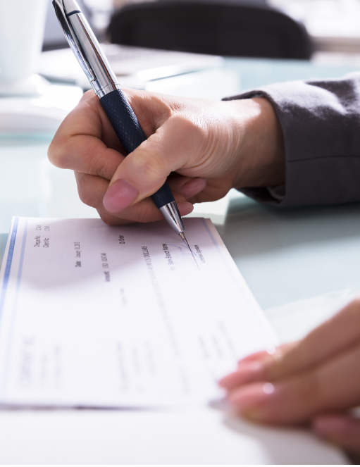 Woman signing paychecks from PEO services