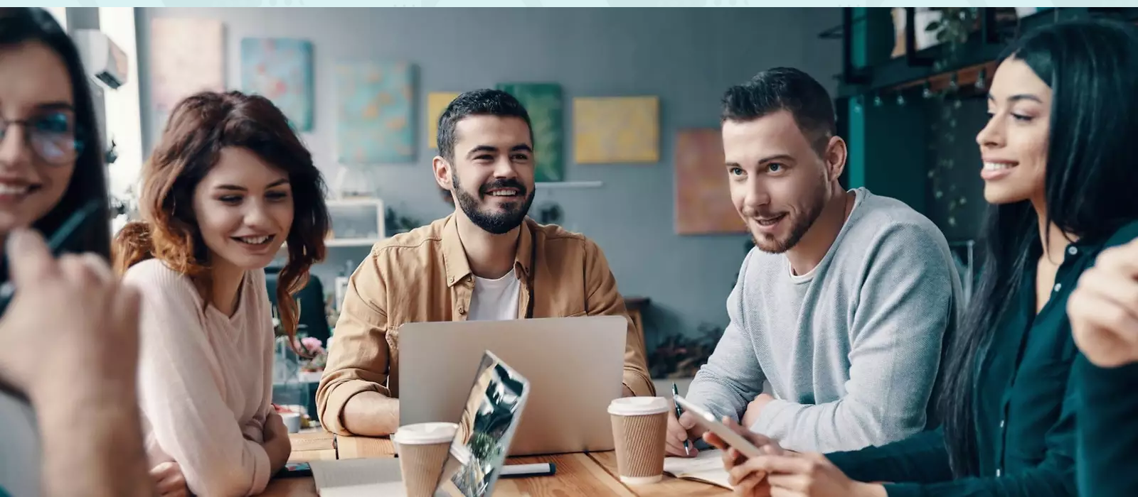 Employees conversing around a table