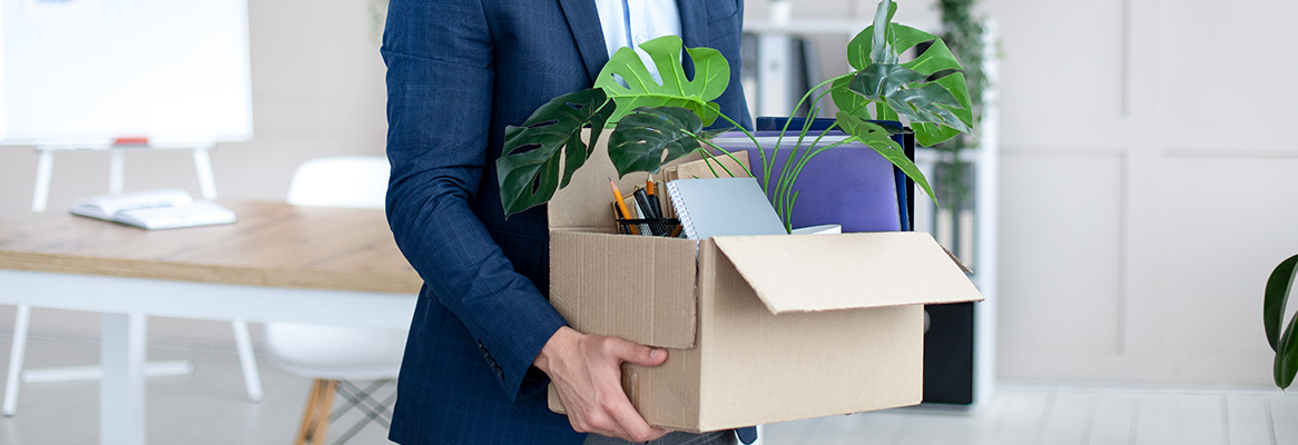 Now unemployed person moving their belongings out of an office